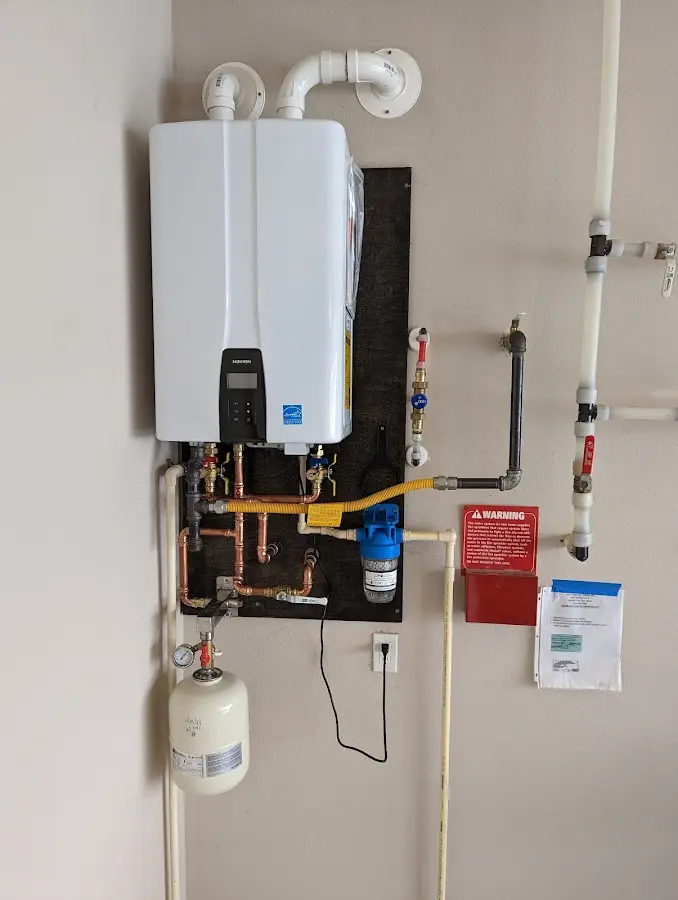 Professional plumber installing copper piping in a Osceola home